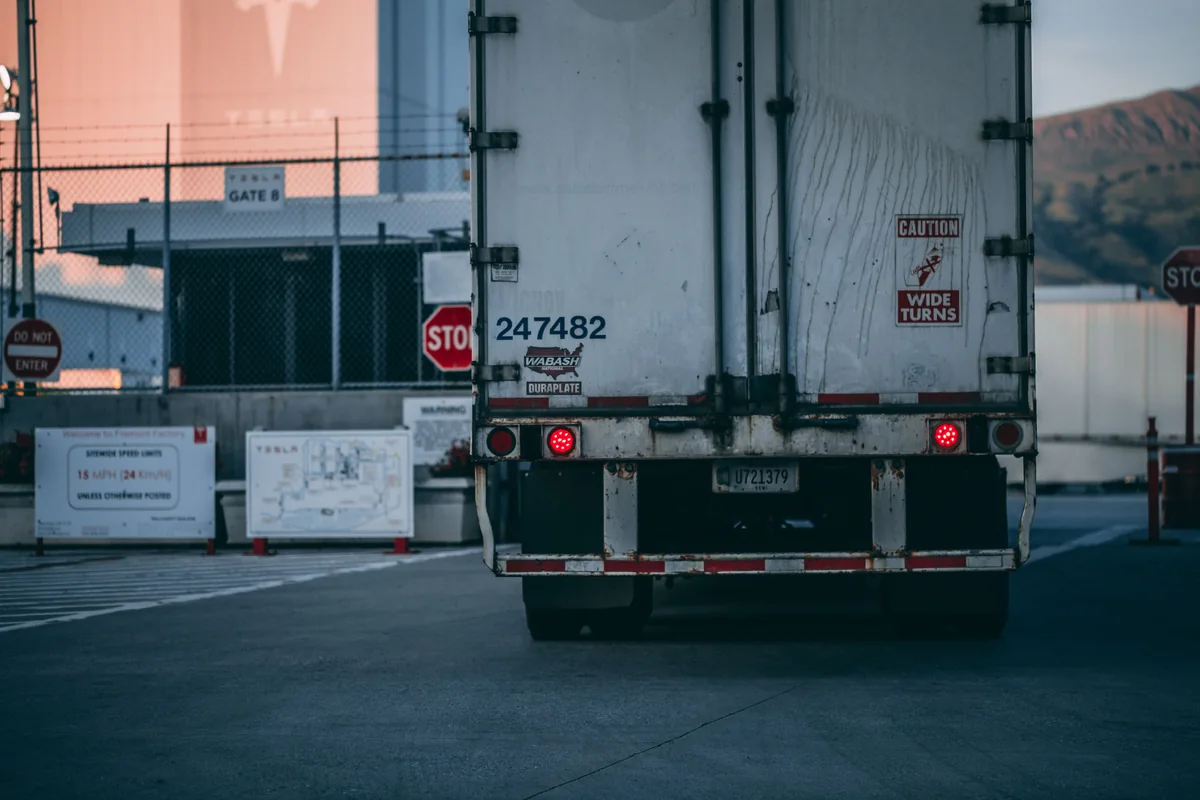 The rear of a freight trailer at an industrial loading area.